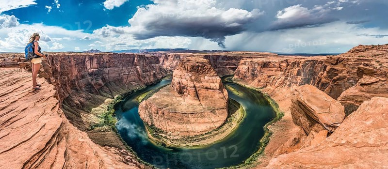 Tourist on a rock overlooking the Horseshoe Bend