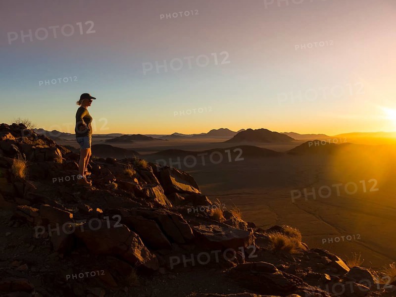 Woman at sunset overlooking Tsaris Mountains