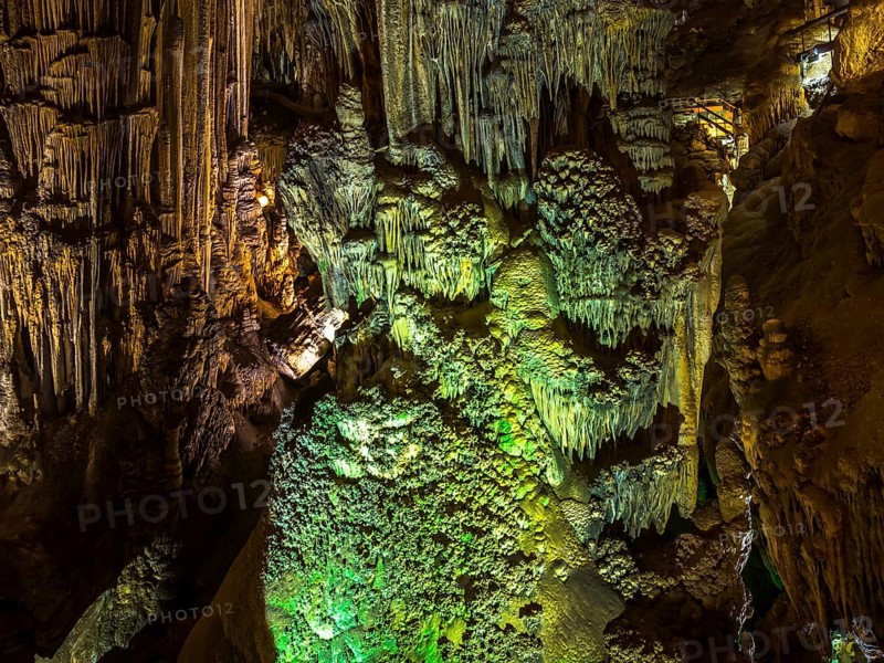 Stalactites in the colorfully lit cave Cuevas de Nerja
