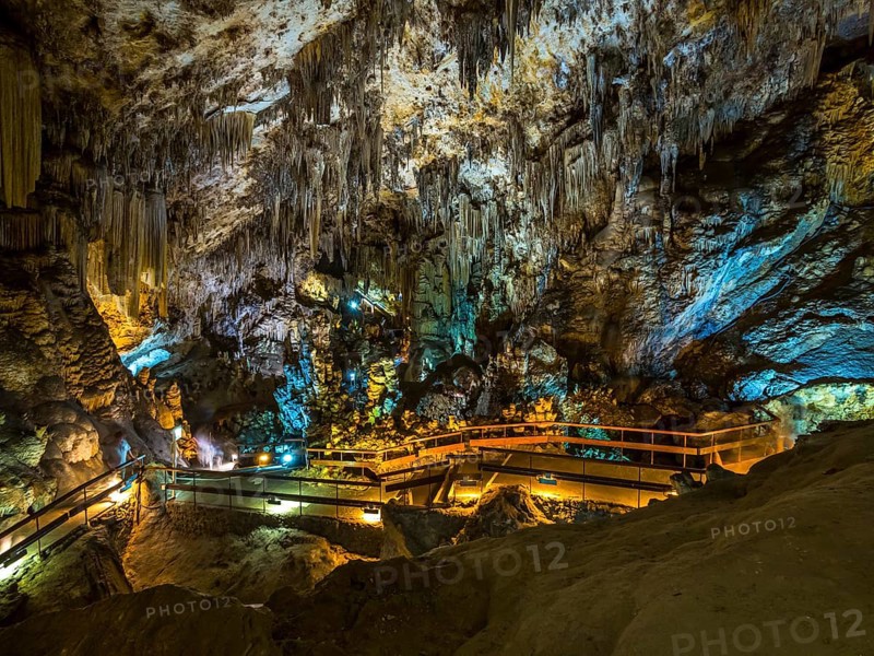Stalactites in the colorfully lit cave Cuevas de Nerja