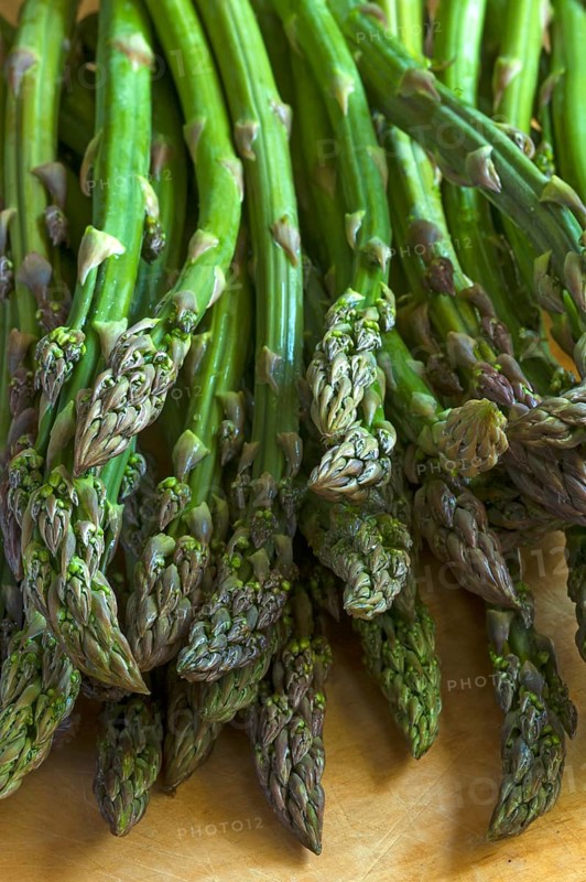 Fresh green asparagus on a wooden board