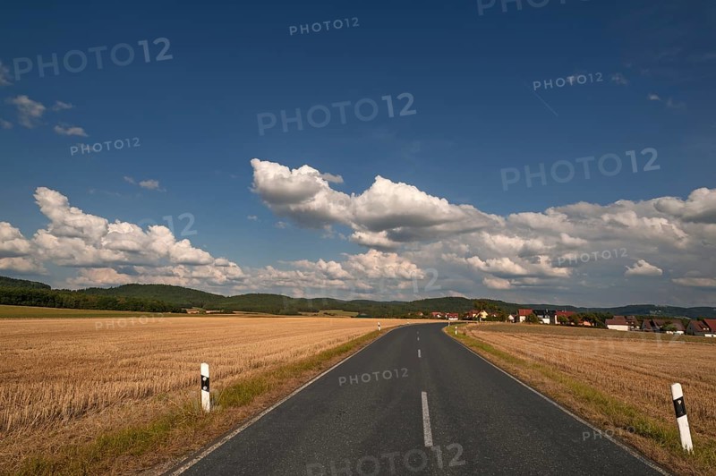 Road between mown down fields