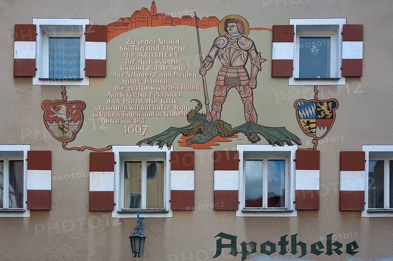 Mural with inscription and the St. George and the Dragon on the town pharmacy