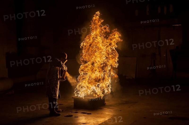 Firefighter extinguishes a heptane 2B-Pan fire with a 2-BTP extinguisher