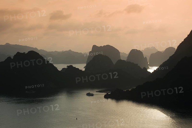 Boat on the water at sunset in the Ha Long Bay or Vinh Ha Long