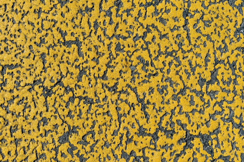 Yellow paint on asphalt