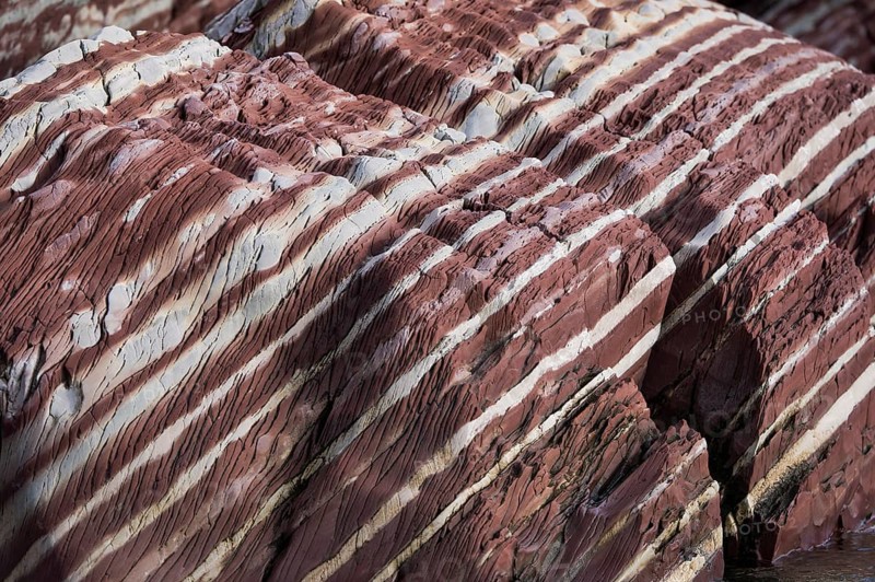 Limestone coloured red by iron and whitish-yellow dolomite