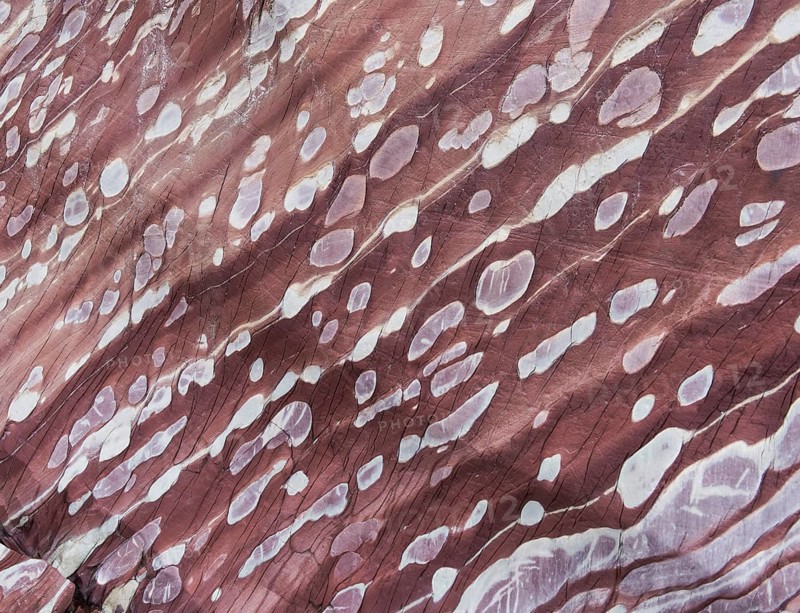 Limestone coloured red by iron and whitish-yellow dolomite