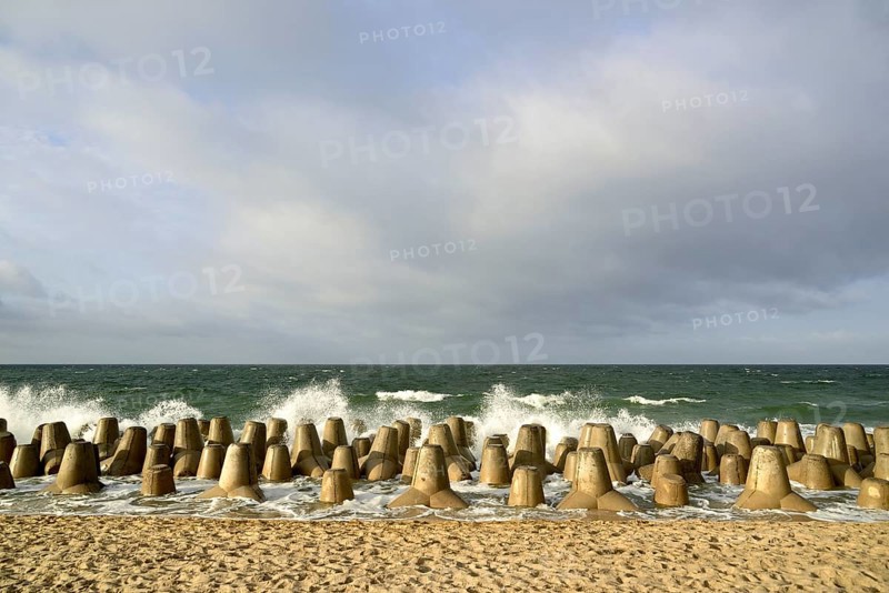 Waves break at concrete breakwaters