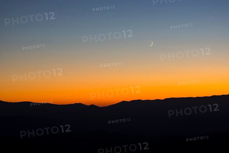 Sunset and crescent moon over the Sibillini Mountains