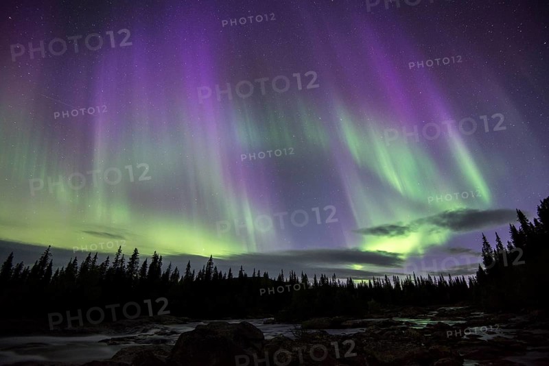 Northern Lights or Aurora Borealis over the river Gamajahka or Kamajakka