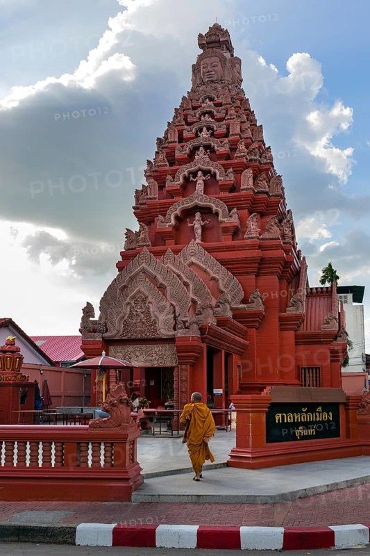 Monk in front of the Khmer-style City Pillar Lak Muang