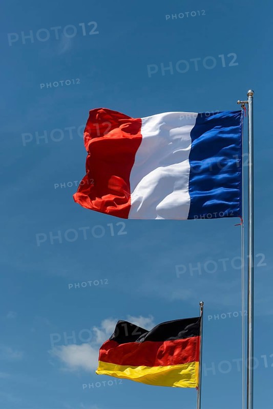 German and French flag blowing in the wind