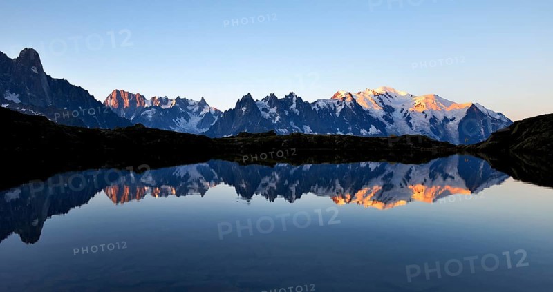 Mont Blanc massif at sunrise reflected in Lac de Chesserys