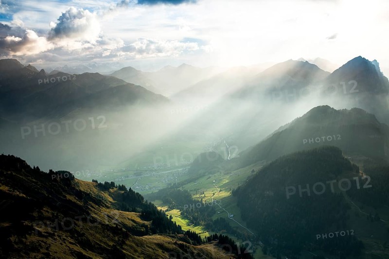 Landscape with sunbeams on the Diedamskopf with view towards Kanisfluh and Damuls