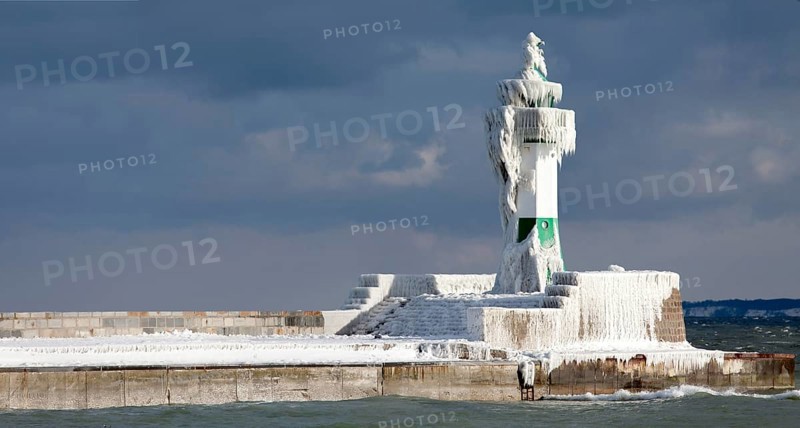Icy lighthouse in harbour