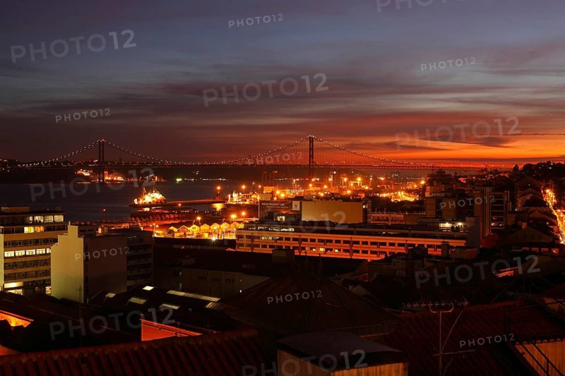 View from Miradouro de Santa Catania on the Bairro Alto and Ponte 25 de Abril at dusk
