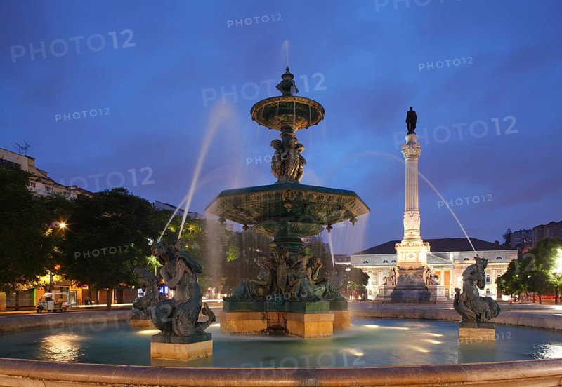 Bronze fountain monument Pedro IV. on Rossio square at dusk