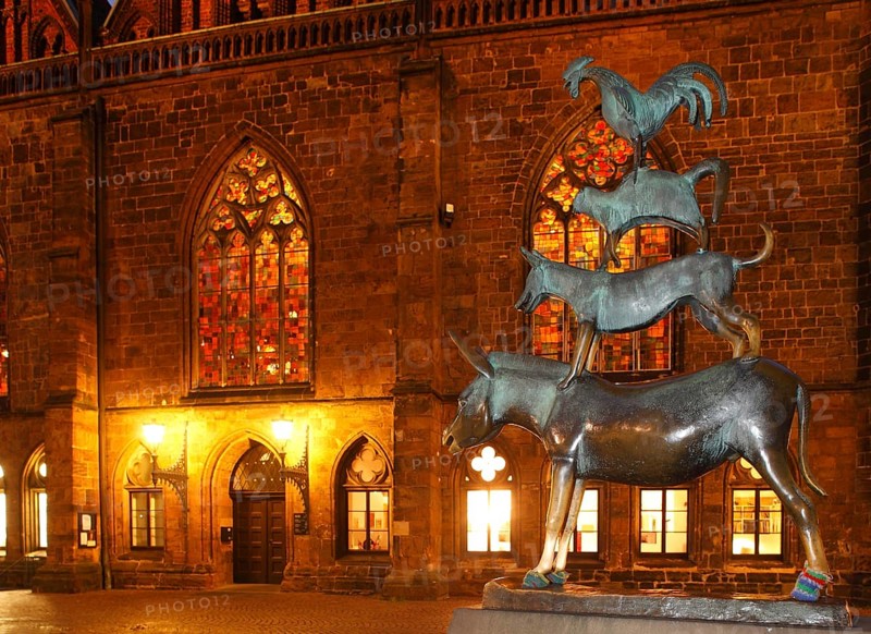 Bremen Town Musicians with illuminated windows of the Church of Our Lady