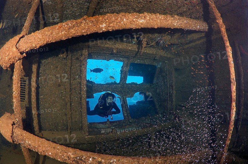 Diver looking at the engine room of the shipwreck Giannis D.