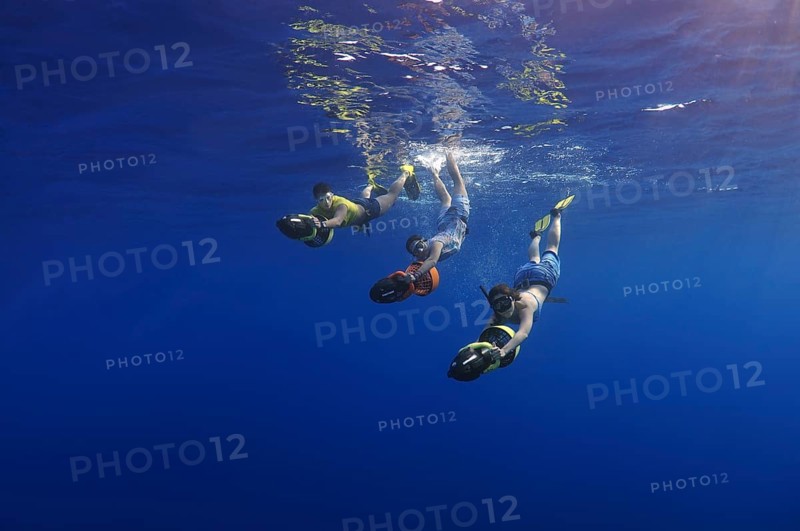Freedivers with underwater scooters