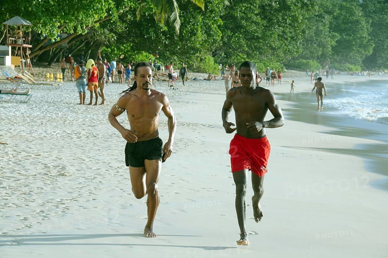 Two Creole men on a morning jog along the beach