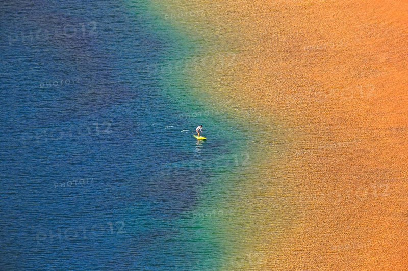 Person with standing paddle in the water