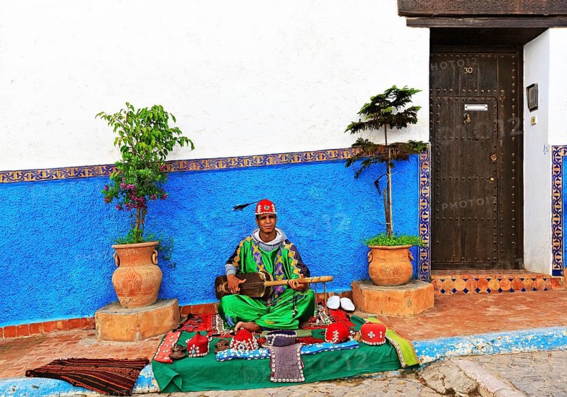 Gnawa musician playing on a Sintir
