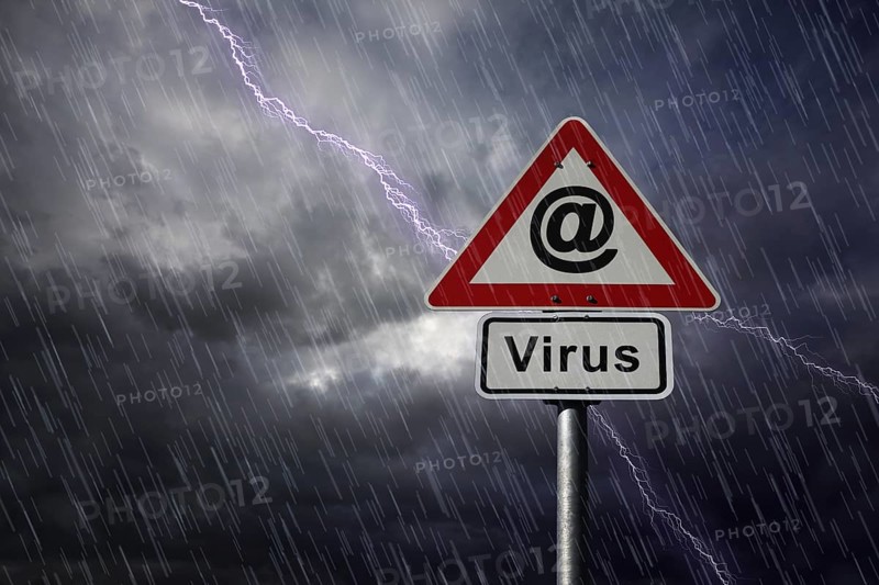 @ symbol and Virus road signs againt a rainy sky with lightning