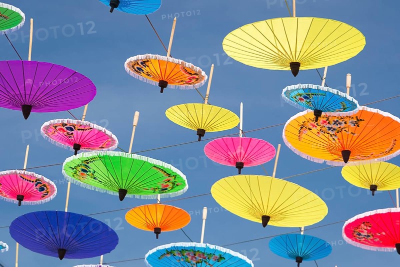 Many colourful umbrellas suspended in mid-air