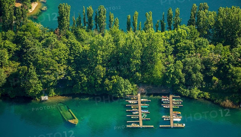 Escher lake with boats docked at a pier