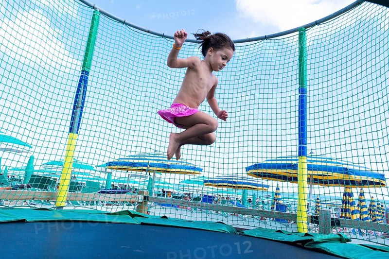 Kid jumping on a trampoline