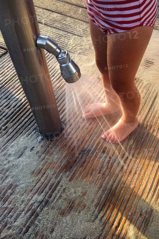 Girl washing sand off her feet