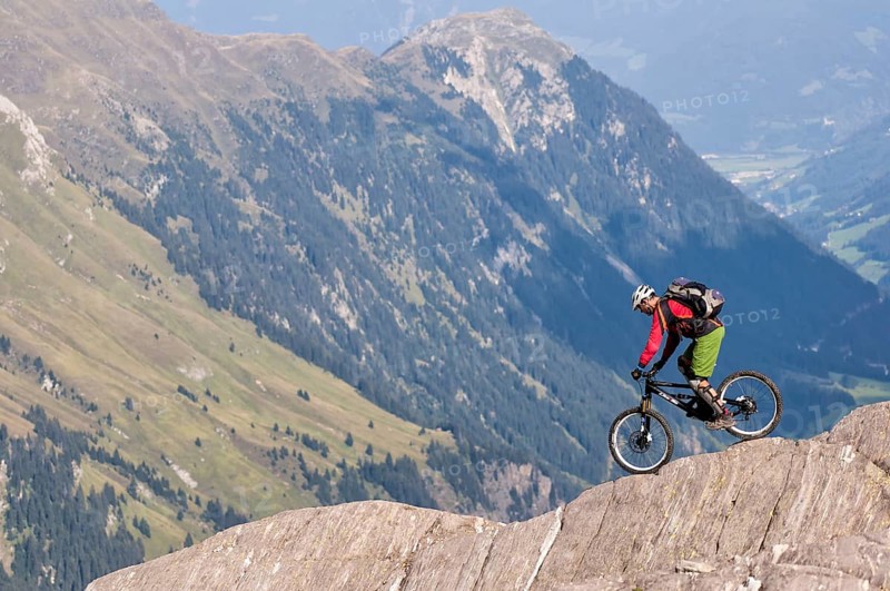 Freeride mountain biker with Liteville riding over cliff edge