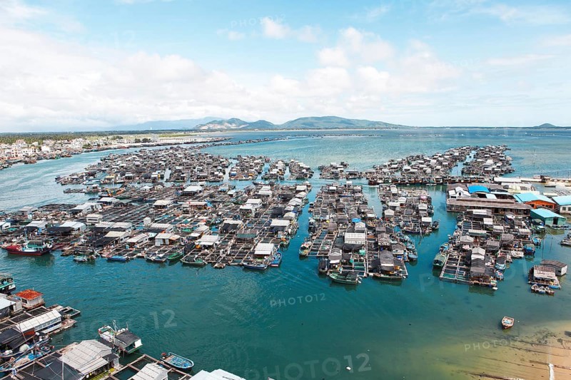 Fishing boats and fish farms in the sea by Monkey Island