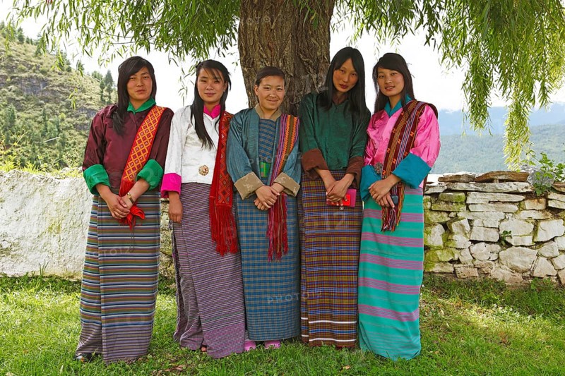 Young women wearing colorful Kira dresses