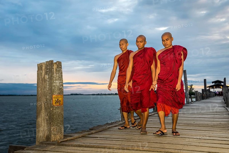 Monks on teakwood bridge