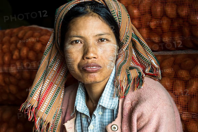 Woman with Thanaka paste on her face during the potato harvest