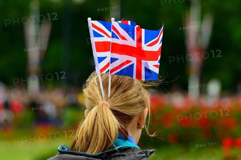 Female fan of the Queen with Union Jack flags on her head