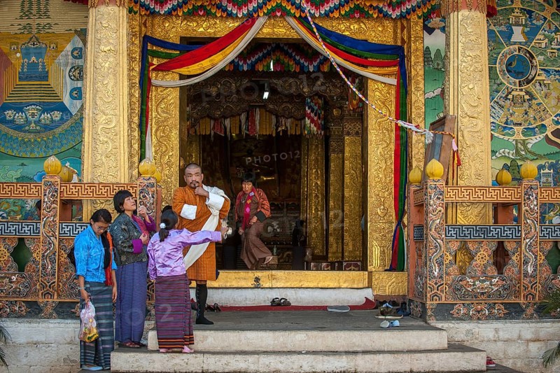 Traditionally dressed family at the entrance of the Dzong temple