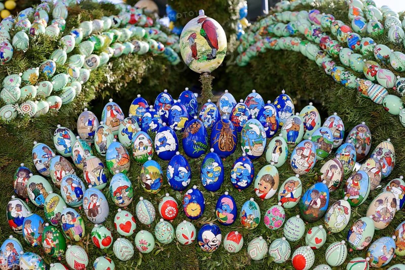 Painted Easter eggs with Igel Mecki cartoons on an Easter well