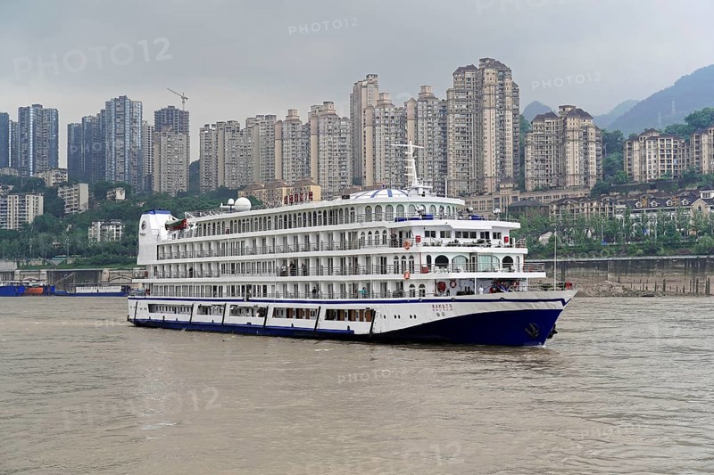 Cruise ship on the Yangtze River with skyscrapers