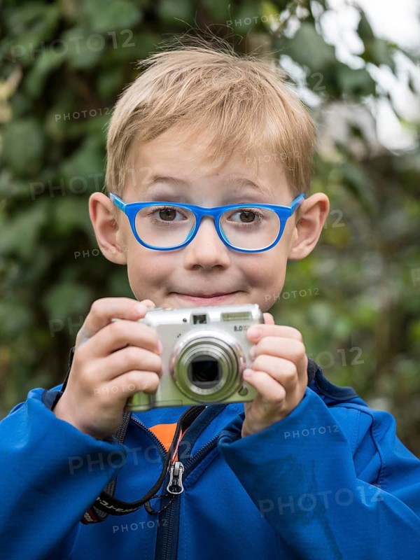 Boy with compact camera
