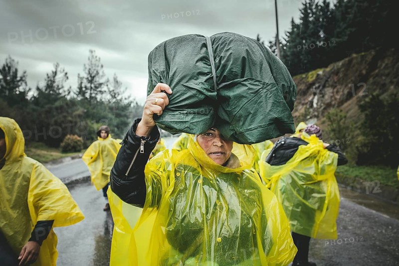 Incoming refugees in rain