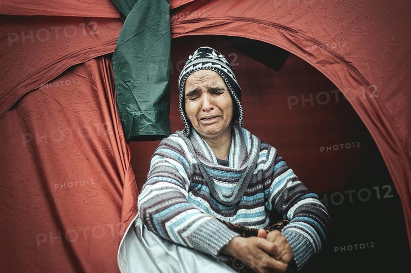 Desperate woman from Afghanistan weeping in her tent
