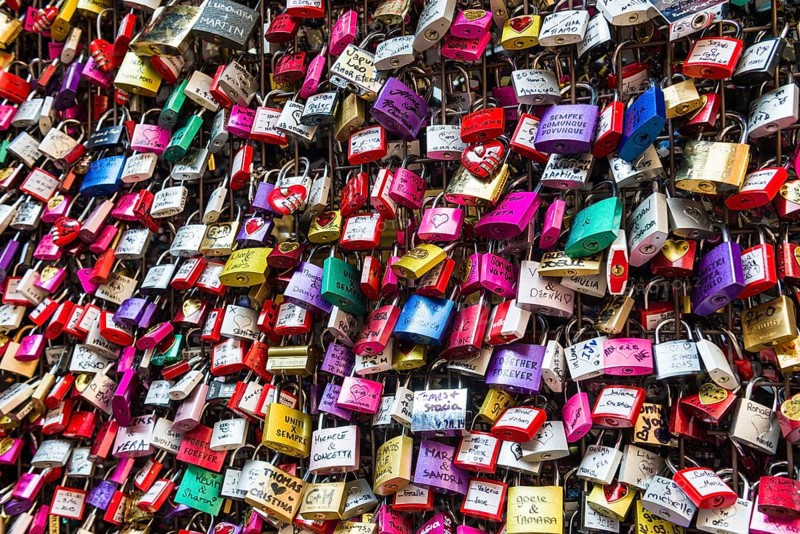 Many colourful love padlocks at the wall of Juliet's house