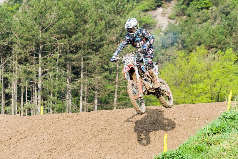 Motorcyclist on a motocross bike jumping through the air