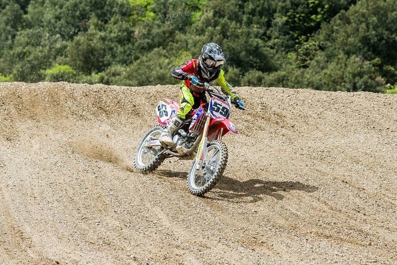 Motorcyclist on a motocross bike riding on a dirt track