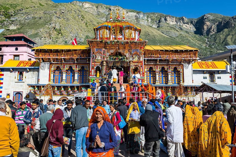 Many pilgrims are gathering in front of the colourful Badrinath Temple