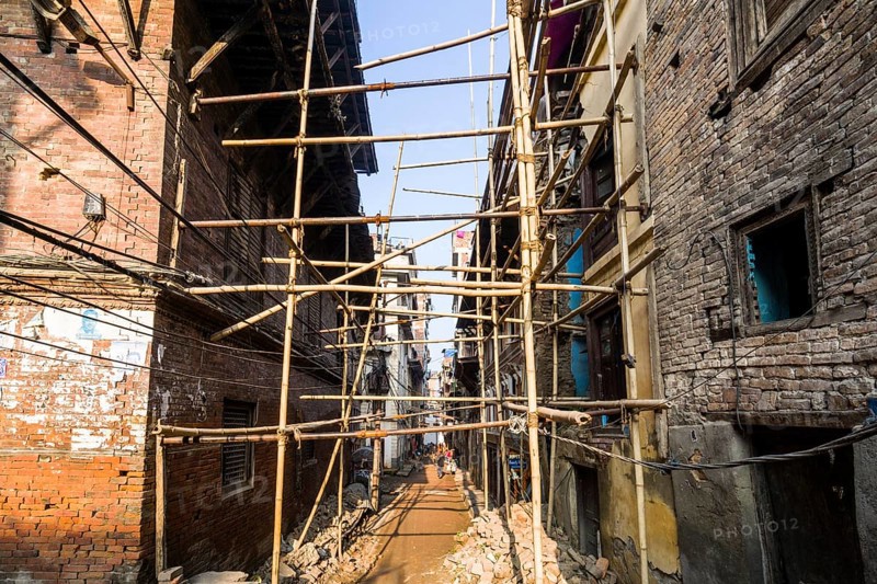 Damaged houses are stabilized by bamboo poles after the 2015 earthquake